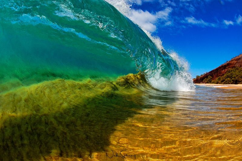 In this print, sand sucks up into the barrel of the wave as it crashes into Makena Beach. Shop this print & a variety of Hawaii photography prints for sale.