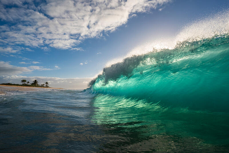 In this stunning wave photo, a large wave swells to then crash into Sandy Beach in Oahu. Shop this print & a variety of crashing waves photography for sale.