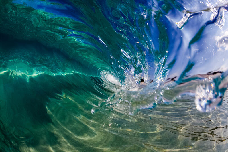 In this gorgeous image, the Hawaiian wave barreling over looks as clear as liquid glass. Shop this print & a variety of wave photography we have for sale.