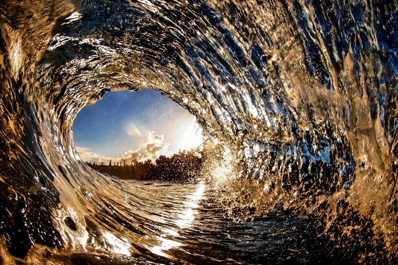 In this golden wave photo a wave catches the golden light as it crashes into Flemming Beach in Maui. Shop this print & a variety of Maui Hawaii wave photography