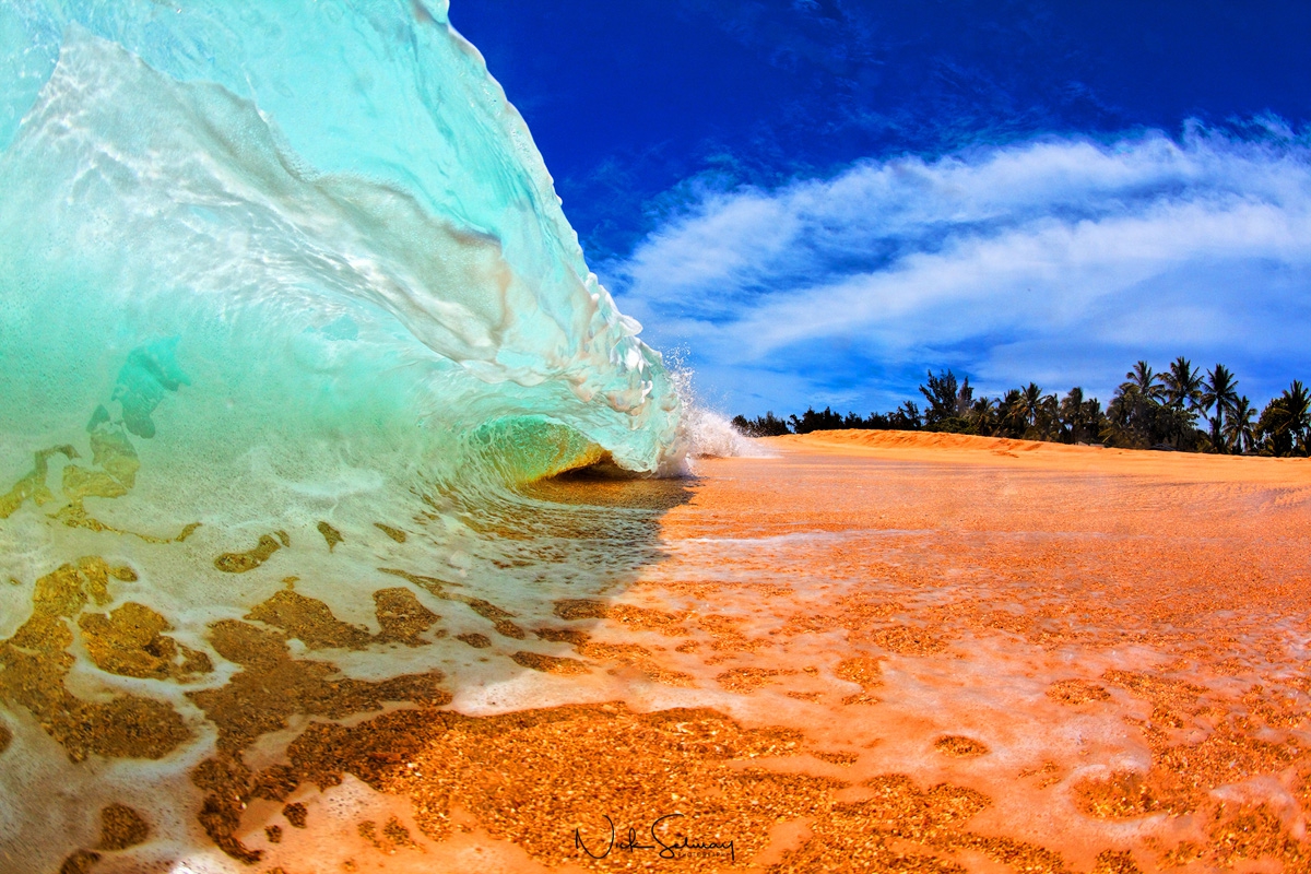 In this beautiful photo, a small wave crashes into the shore in Keiki Beach in Oahu. Shop this print & a variety of Hawaii shorebreak photography for sale.