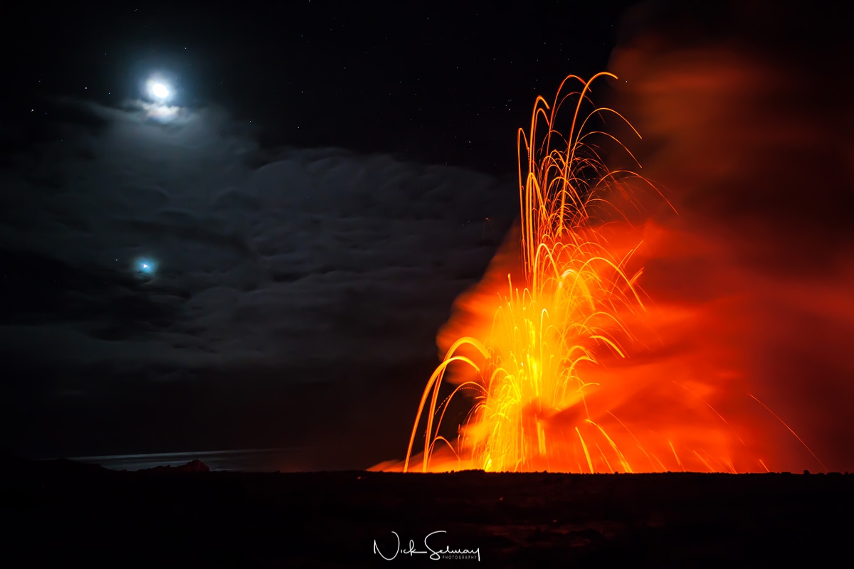 In this moonlit image, lava explodes from a volcano standing out vibrantly from the night sky. Shop this print & a variety of photos of volcanos & lava for sale