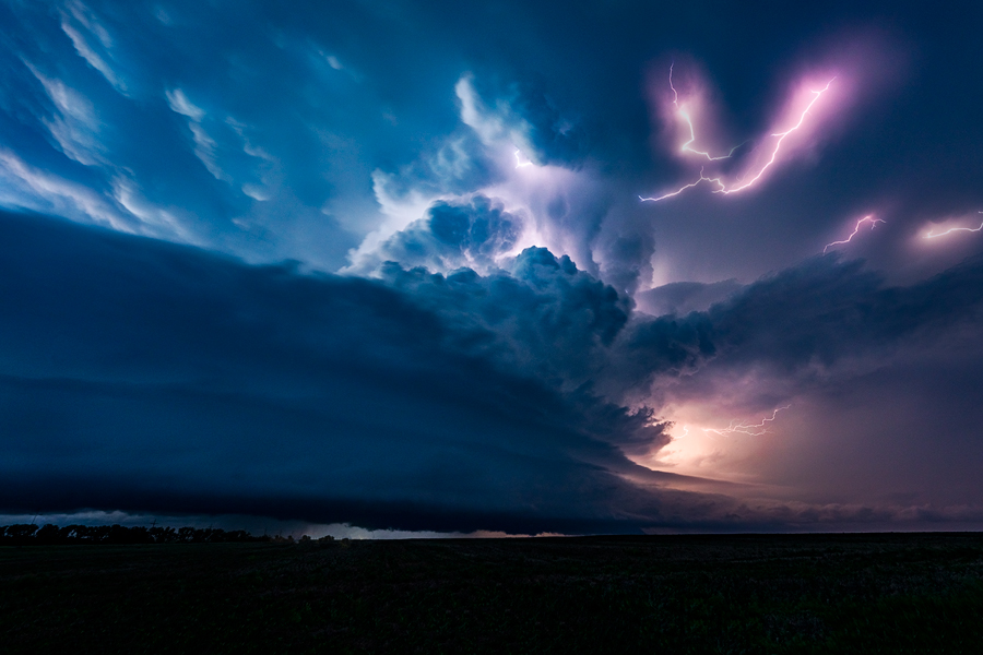 A stunning supercell storm at night dances along the plains of Kansas putting on a show for the ages.