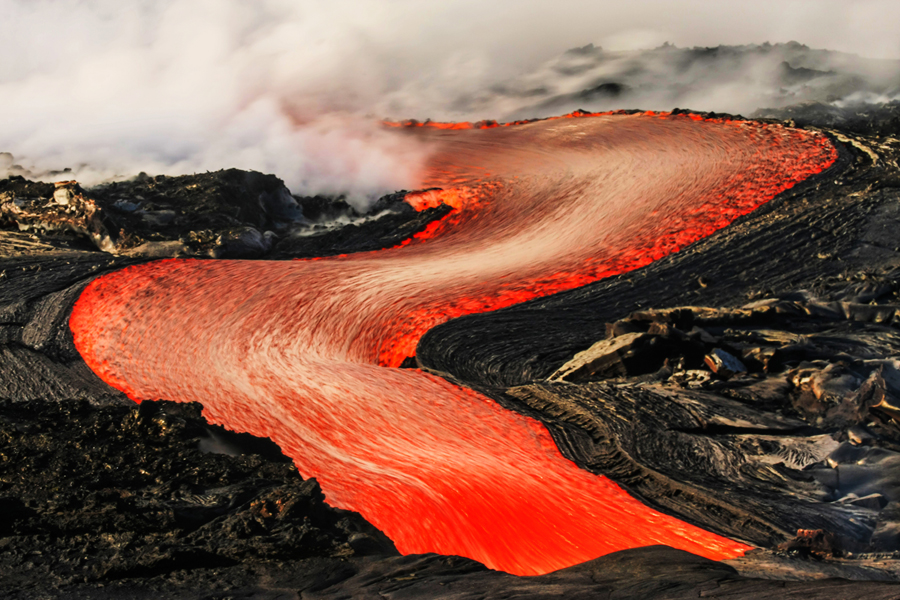 In this stunning image of molten lava in Hawaii, a lava river speeds through towards the ocean. Shop this print & a variety of images of molten lava for sale.