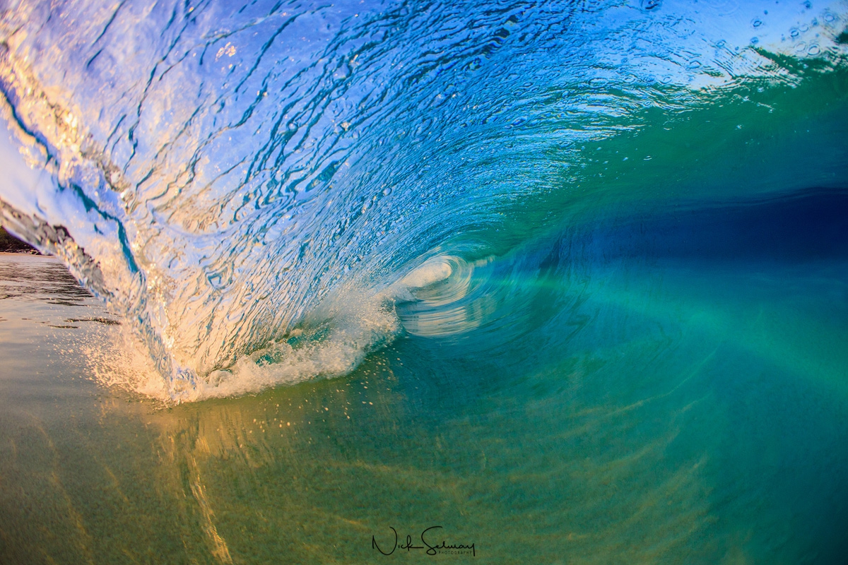 In this photo of a big wave in Hawaii, a smooth and serene wave rolls in the ocean gracefully. Shop this print & a variety of big wave photography in Hawaii.